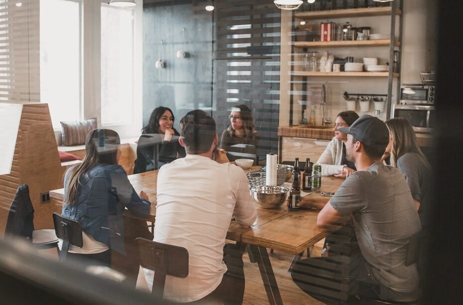 Designer reviewing cabinetry finishes with a Ronbow consultant in a showroom or workspace.